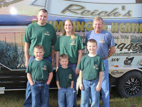 Reich Family in front of Reich's Plumbing & Heating company vehicle