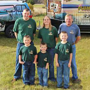 Reich Family in front of Reich's Plumbing & Heating company vehicle